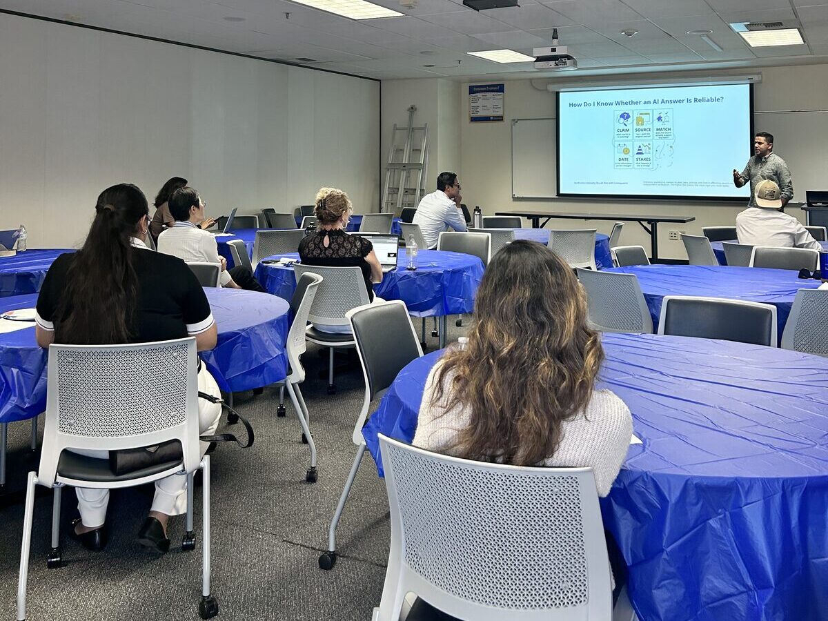 Students and guests at round tables listening to Dr. Pira's talk in BDC 262B
